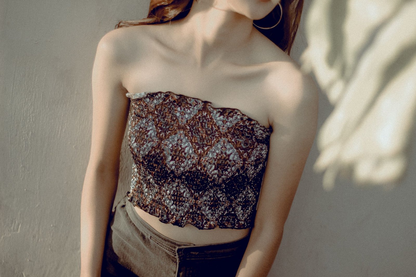 Portrait of a woman in a strapless top with elegant lighting, perfect for fashion or lifestyle themes.