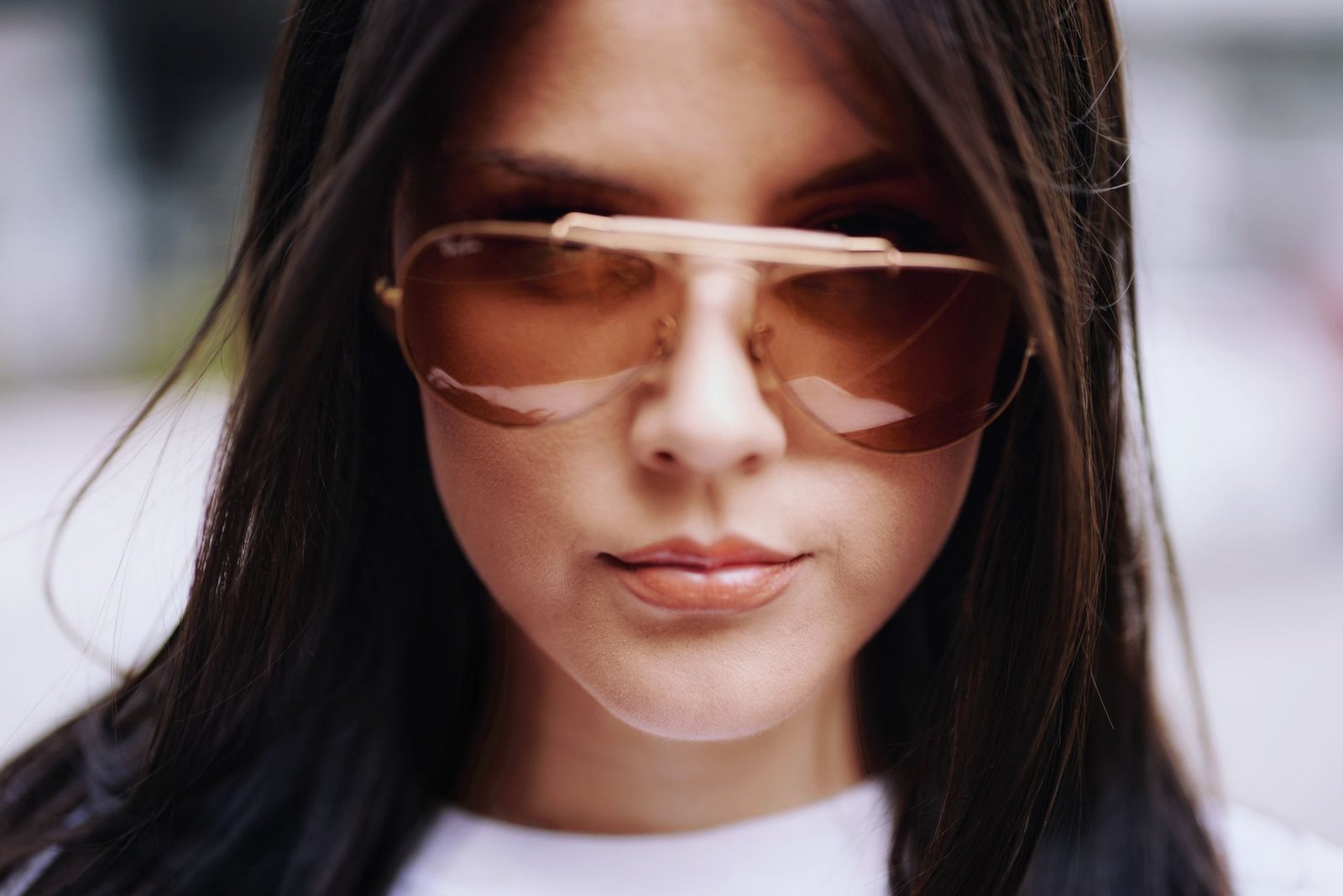 Close-up portrait of a woman in sunglasses featuring stylish fashion and elegance. Perfect for editorial use.
