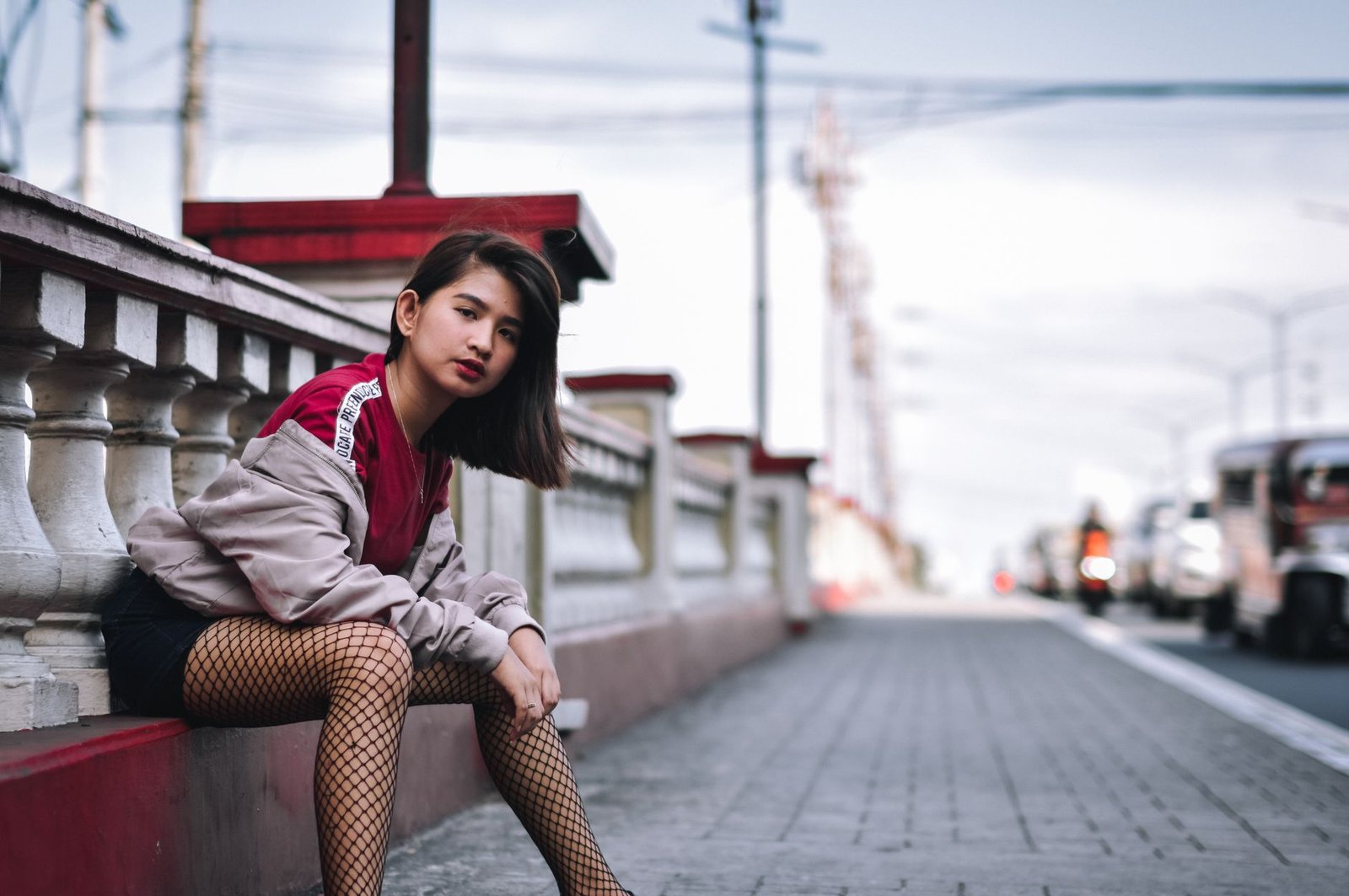 Stylish fashion model in urban street setting, showcasing modern streetwear style.