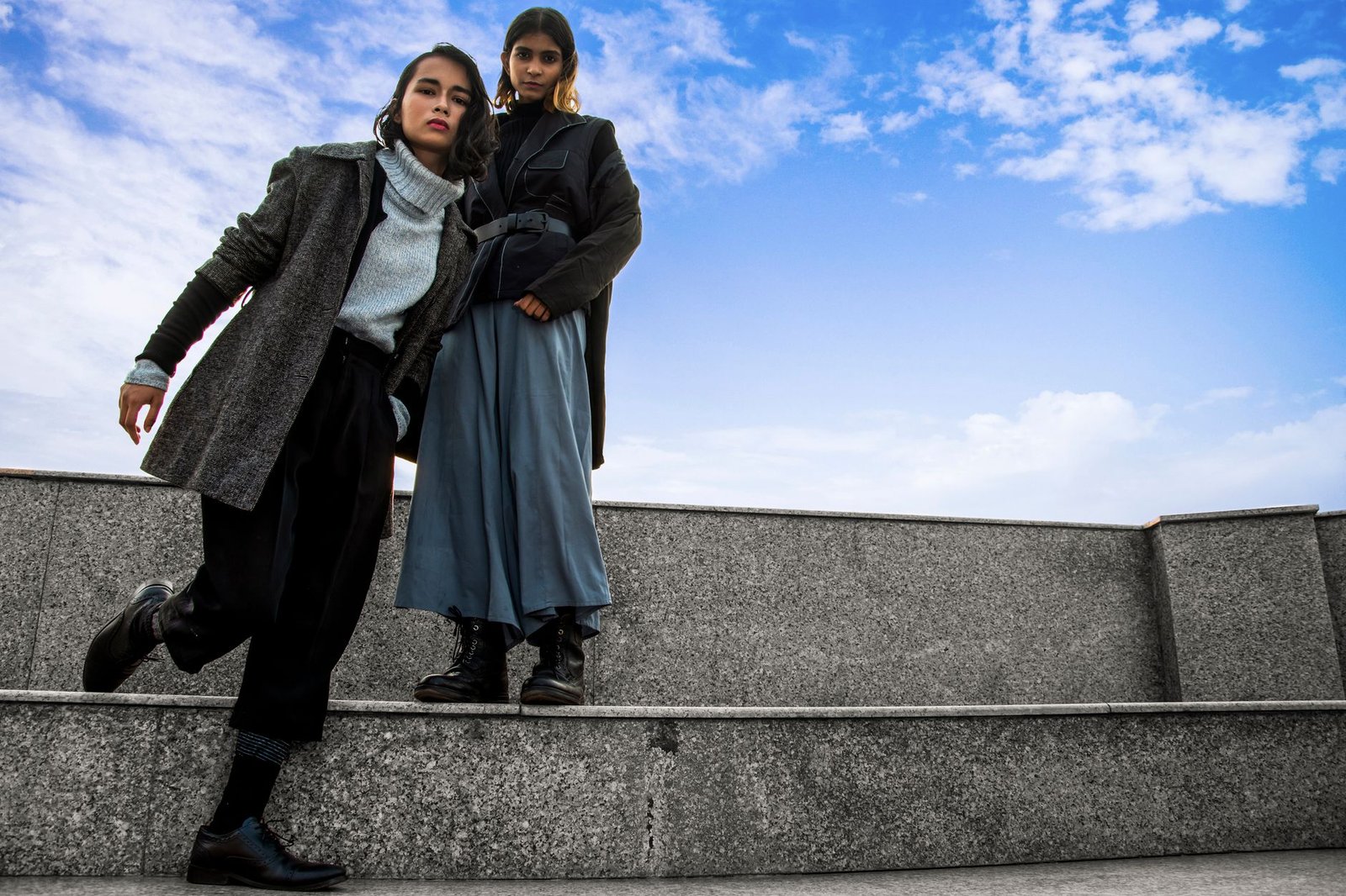 Two women in stylish attire posing outdoors in Patna, India.