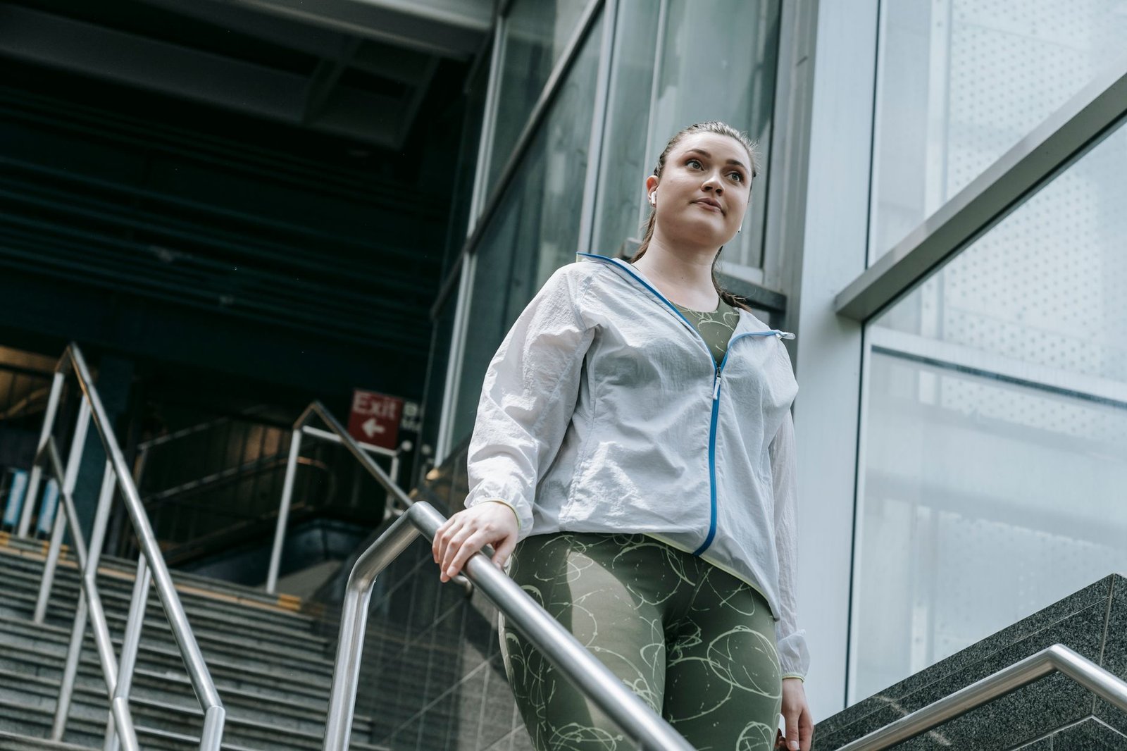 Active woman in sportswear walking down stairs, capturing a moment of motivation.