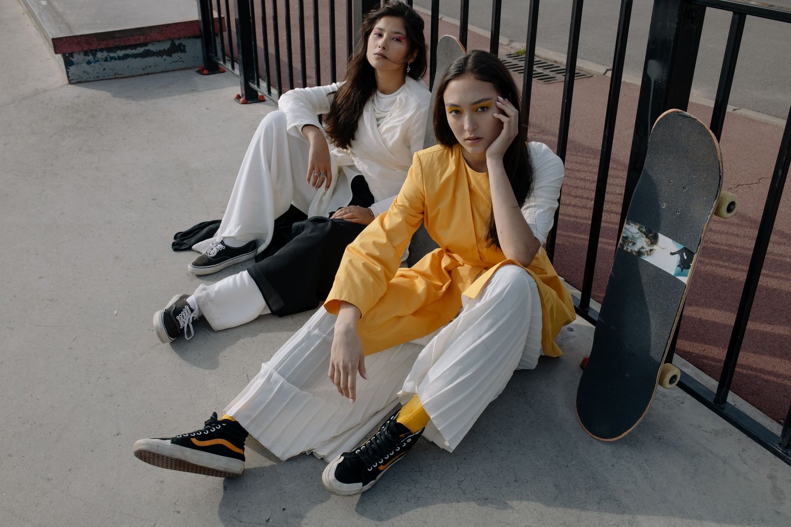 Stylish women in a skatepark showcasing modern urban fashion.