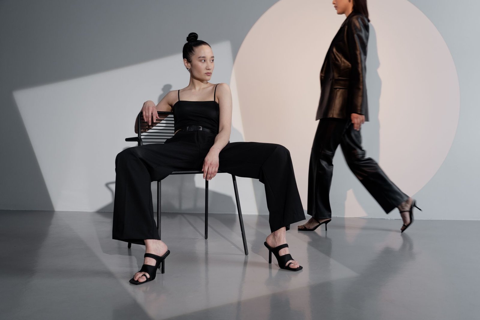 Stylish women posing in a modern studio setting, embracing contemporary fashion and elegance.