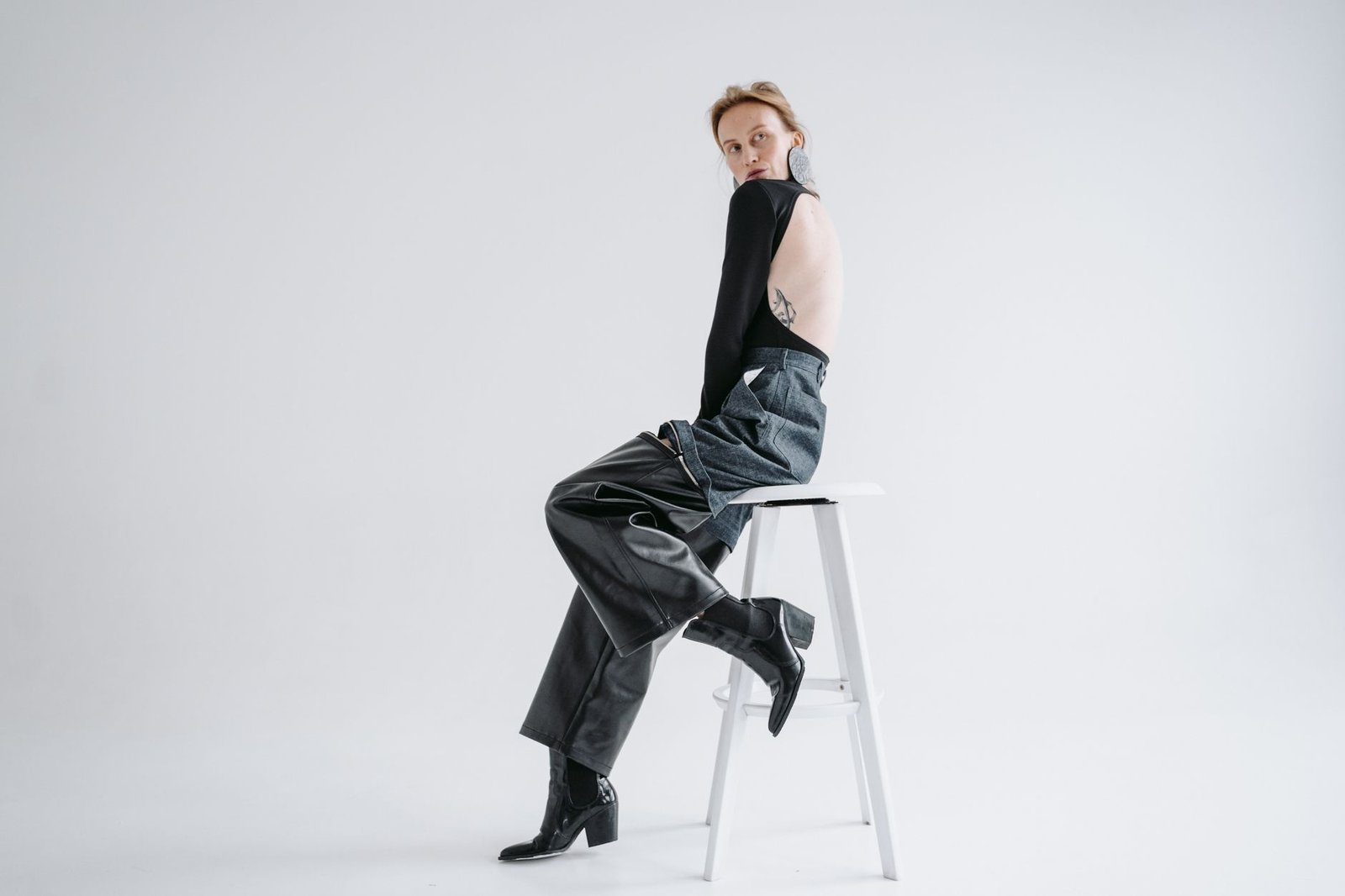 Knee high leather boots straight jeans tucked fashion
