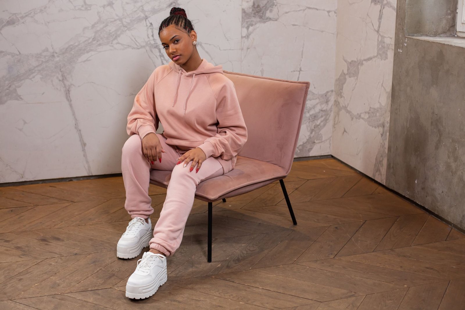 Velour tracksuit with elevated footwear as fashion choice