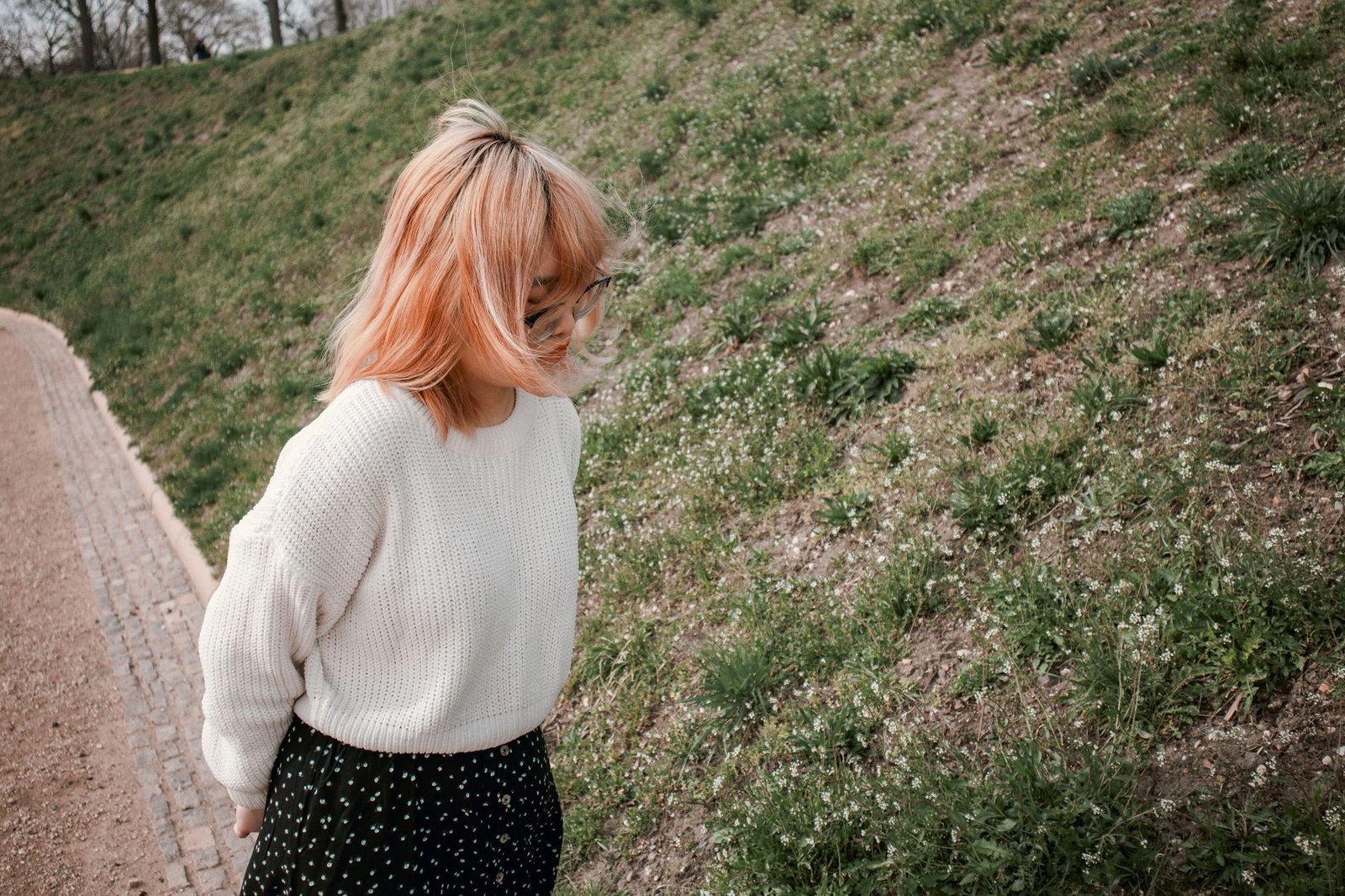 Pastel knitwear layered over tee with white jeans