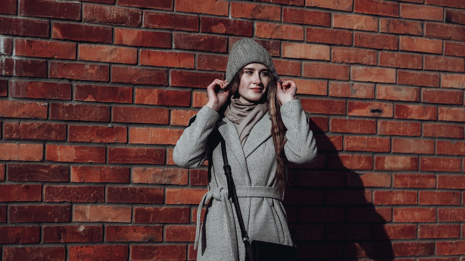 Long coat over hoodie winter streetwear look