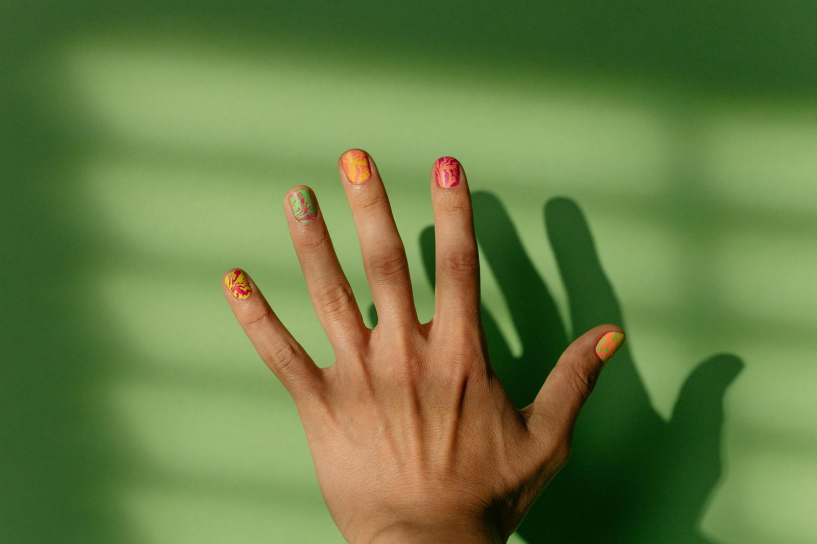 Sunset nails showing vibrant colorful manicure technique